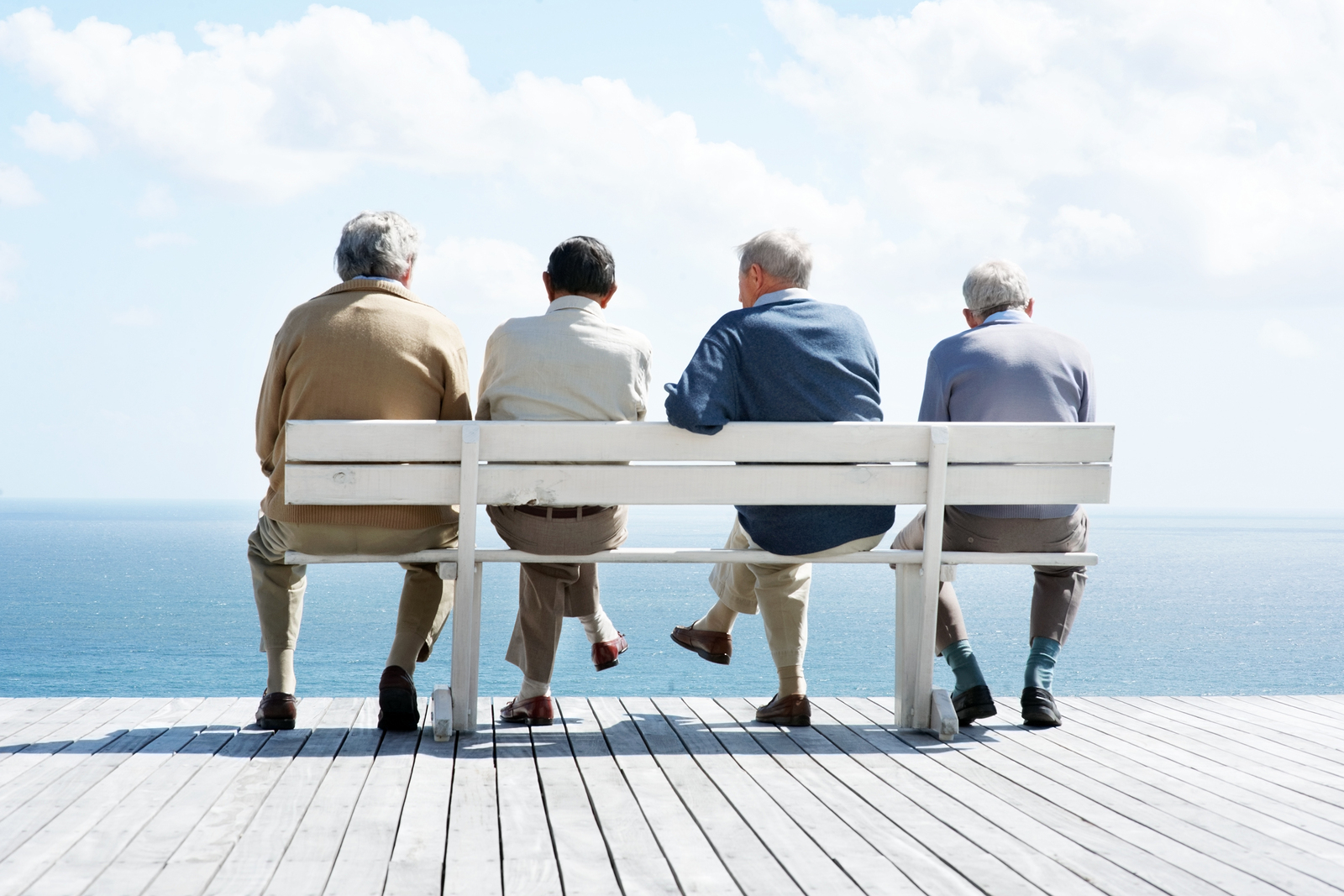 4 old men sitting on a bench
